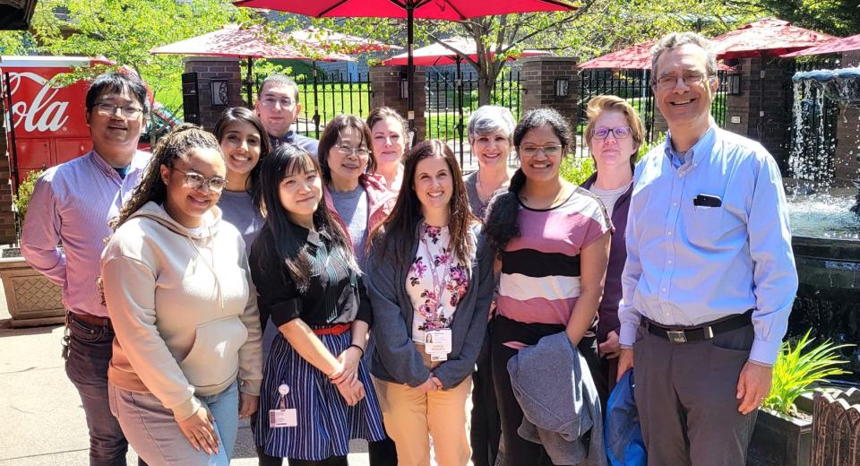 The image shows the Kuhn and Liu lab team members at a lunch event